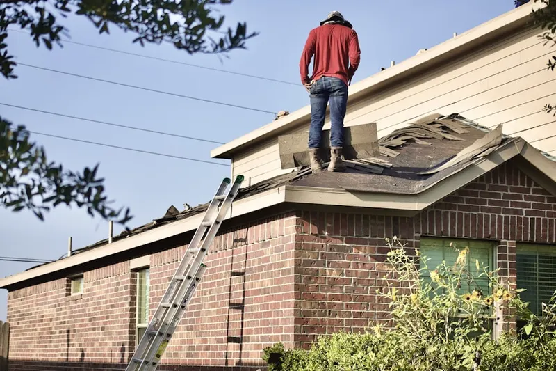 Professional roofer working on a residential roof in Franklinville